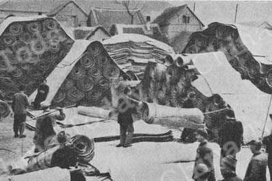 
Straw matting, woven by peasants, piled up at a cooperative ready for shipment to town.
